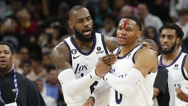 SAN ANTONIO, TX - NOVEMBER 26: LeBron James #6 of the Los Angeles Lakers checks on Russell Westbrook #0 of the Los Angeles Lakers after he received a hit on a drive to the basket by Zach Collins #23(not in frame)  of the San Antonio Spurs in the second half at AT&T Center on November 26, 2022 in San Antonio, Texas. NOTE TO USER: User expressly acknowledges and agrees that, by downloading and or using this photograph, User is consenting to terms and conditions of the Getty Images License Agreement. (Photo by Ronald Cortes/Getty Images)