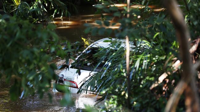 A 44-year-old woman is dead after her car was swept away in floodwaters in Aspley last night. Pics Tara Croser.