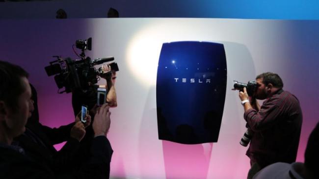 People look at newly-unveiled Tesla Powerwall batteries in Hawthorne, California.