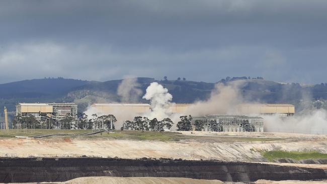 Clouds of white smoke can be seen after the demolition. Picture: David Caird