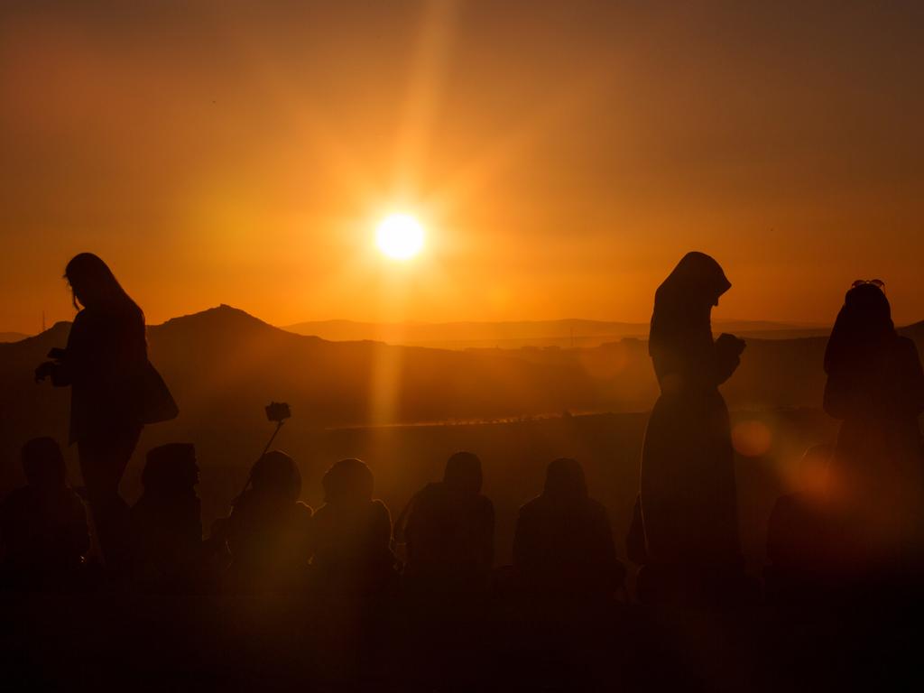 Tourists take photographs from a sunset lookout point on April 16, 2016 in Nevsehir, Cappadocia, Turkey. Picture: Getty