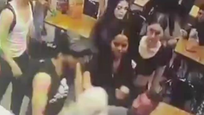 CCTV footage from the fast-food restaurant in Brighton-Le-Sands shows two women trying to fight one another. Picture: 7News