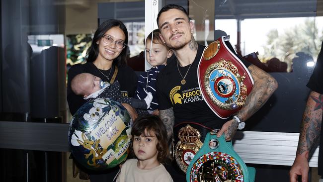 George Kambosos Jr arriving home in Sydney with Teofimo Lopez’s belt and his wife Bec Pereira and their three kids. Picture: Tim Hunter.