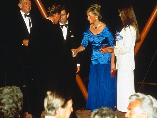 Prince Charles, Prince of Wales and Diana, Princess of Wales, wearing a blue satin dress designed by Bruce Oldfield, stand next to model Elle Macpherson as they attend the Bicentennial Wool Collection fashion show at the Sydney Opera House on January 31, 1988. Photo: Getty Images