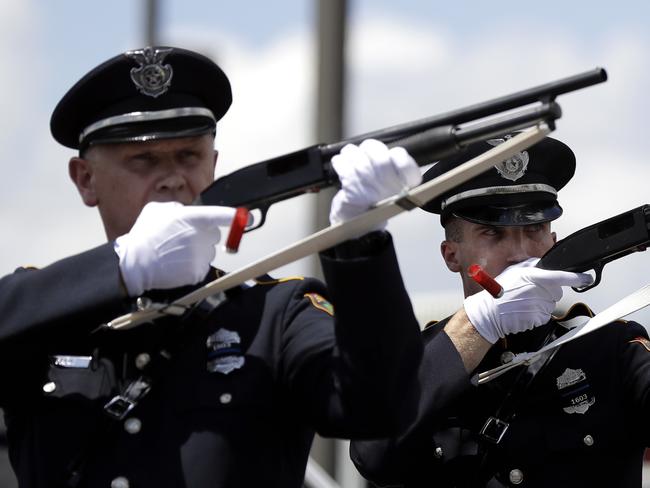 San Antonio Police honour guard fire a 21-gun salute earlier this month during services for police officer Miguel Moreno who died after he and his partner were shot by a man they intended to question about a vehicle break-in. Picture: AFP