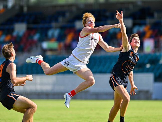 Swans Academy star Christian Webster gets high to punch the ball away from a contest. Picture: Keith McInnes