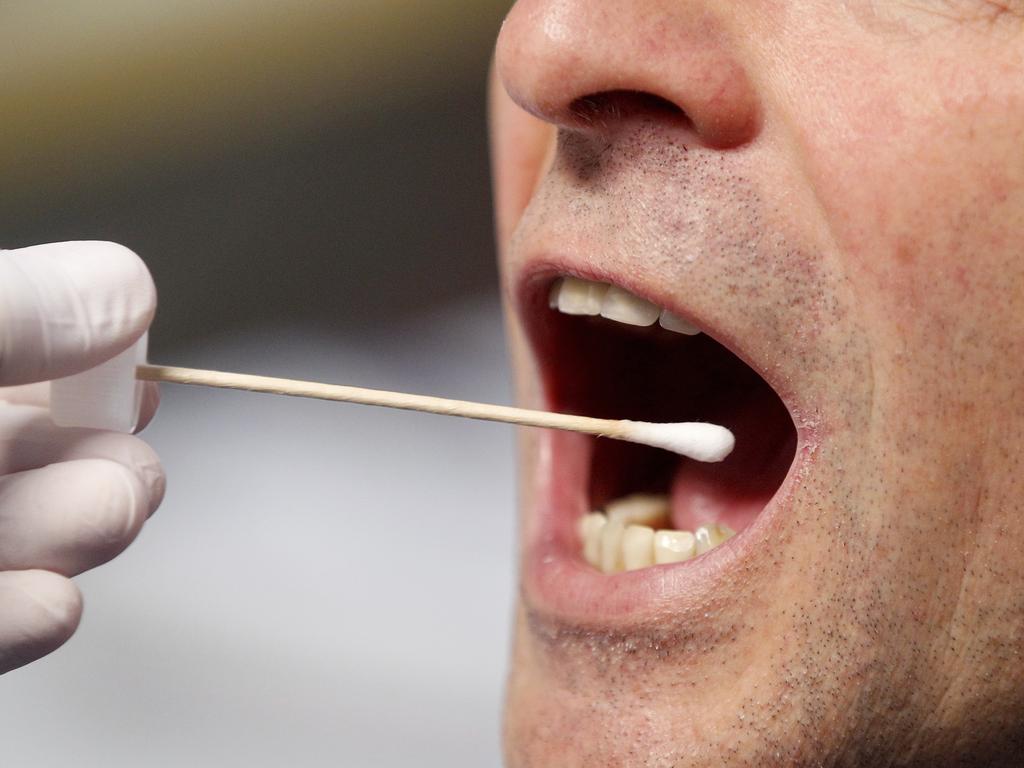A police officer poses to illustrate a saliva test in Grevenbroich, Germany. Picture: AP
