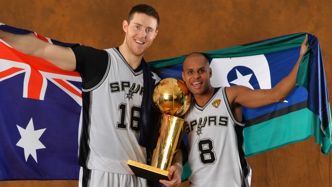 SAN ANTONIO, TX - JUNE 15: Aron Baynes and Patty Mills of the San Antonio Spurs poses for a portrait with the Larry O'Brien Trophy after defeating the Miami Heat in Game Five of the 2014 NBA Finals on June 15, 2014 at AT&T Center in San Antonio, Texas. NOTE TO USER: User expressly acknowledges and agrees that, by downloading and or using this photograph, User is consenting to the terms and conditions of the Getty Images License Agreement. Mandatory Copyright Notice: Copyright 2014 NBAE (Photo by Jesse D. Garrabrant/NBAE via Getty Images)