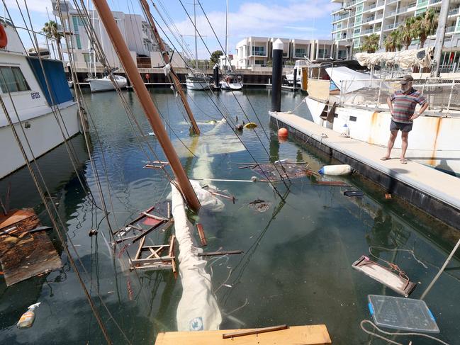 05/01/2021 Dieter Czora surveys the damage of his neighbours boat that sunk over night at the Newport Marina Photo by Kelly Barnes