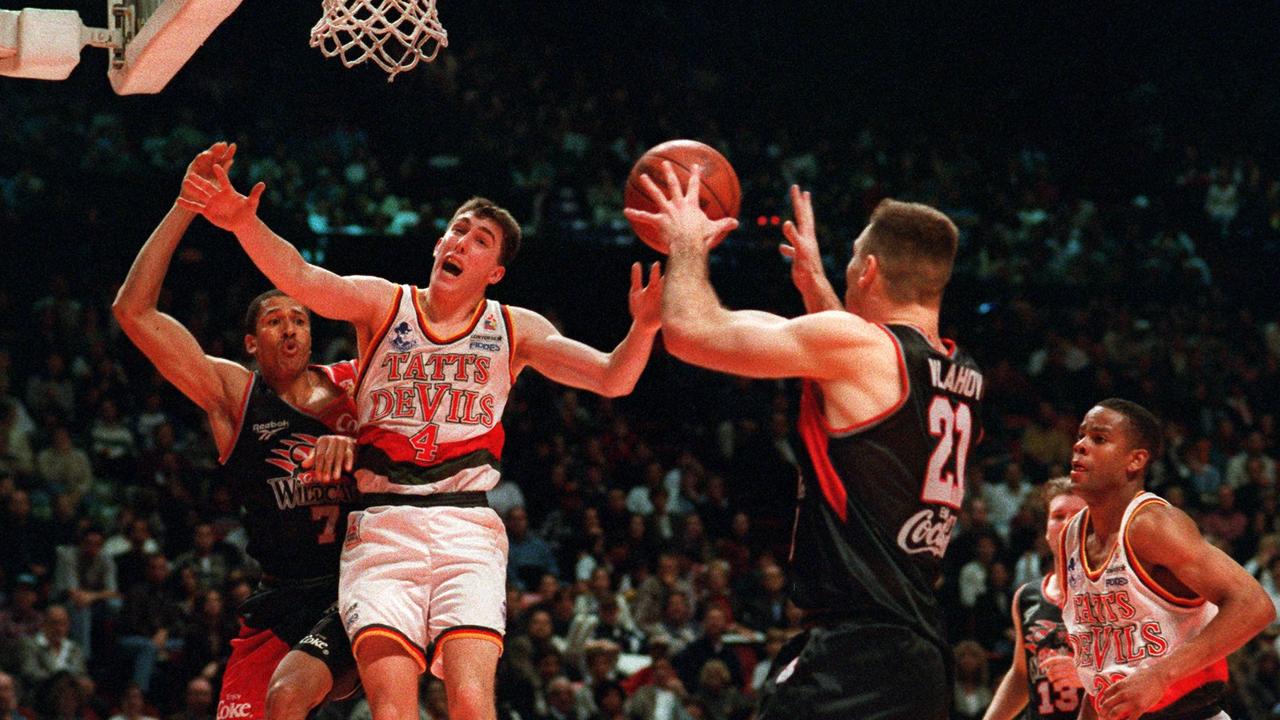 The Perth Wildcats’ James Crawford battles Tassie Devils’ Mark Nash while Wildcat Andrew Vlahov receives the ball in a 1996 NBL clash - the last time a Tasmanian team was in the competition.