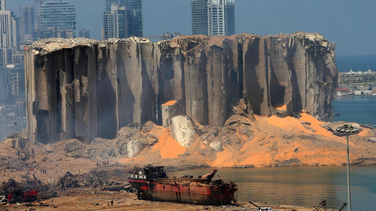 The damaged grain silo and a burnt boat at Beirut's harbour. Picture: AFP