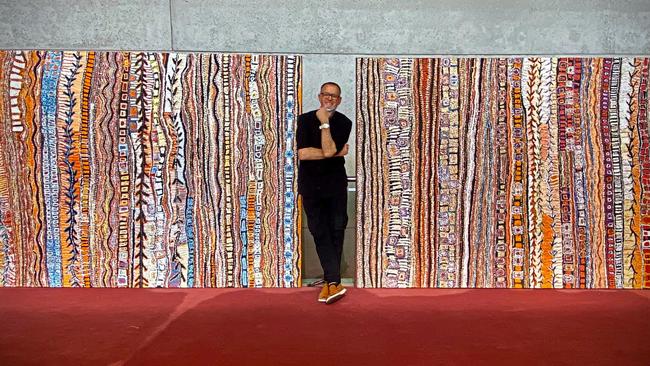 David Hinchliffe with two paintings he commissioned through APYACC.