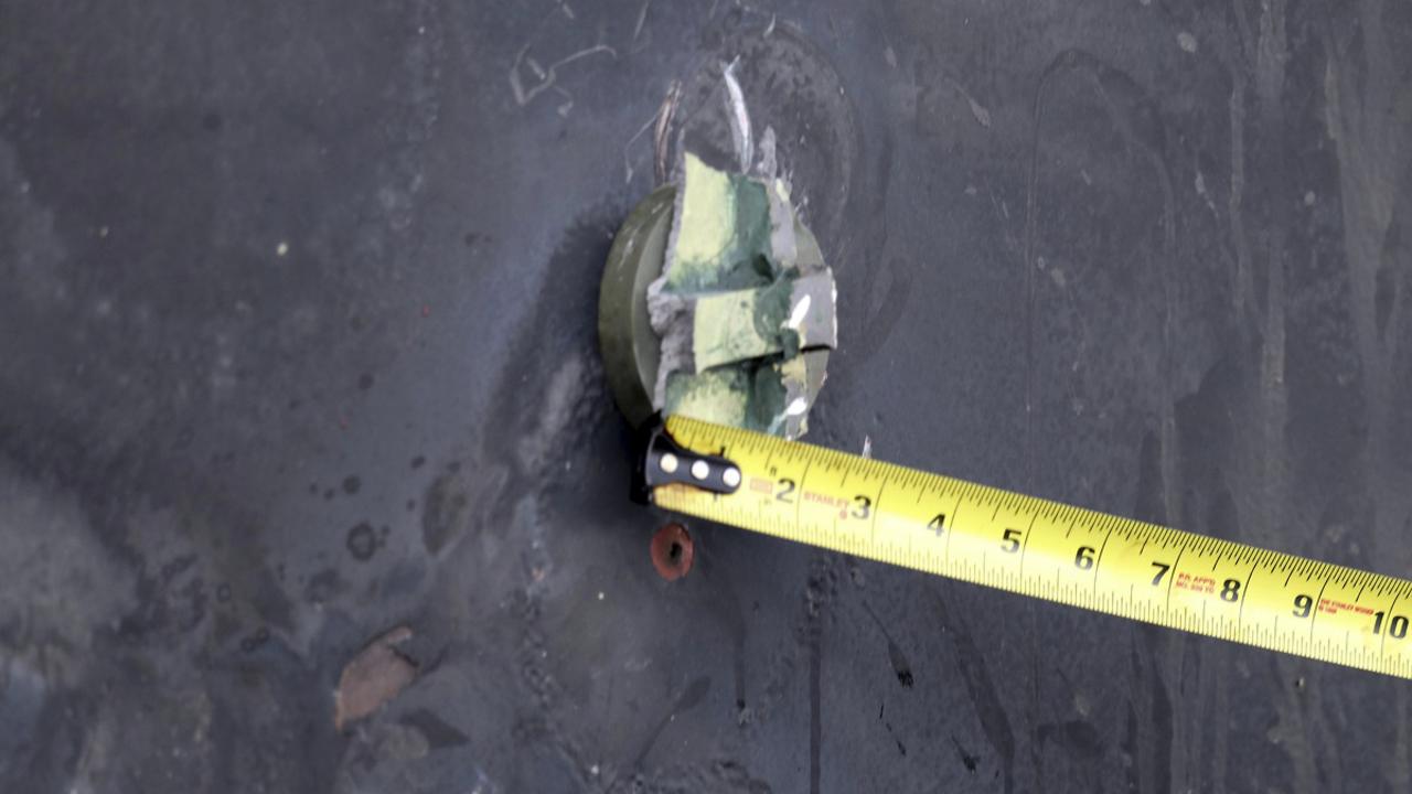 This image reportedly shows the aluminium and green composite material left behind following removal of an unexploded limpet mine. Picture: U.S. Department of Defence via AP