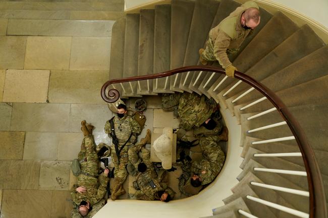 National Guard members sleep, before Democrats begin debating one article of impeachment against U.S. President Donald Trump at the U.S. Capitol, in Washington, U.S., January 13, 2021. REUTERS/Joshua Roberts