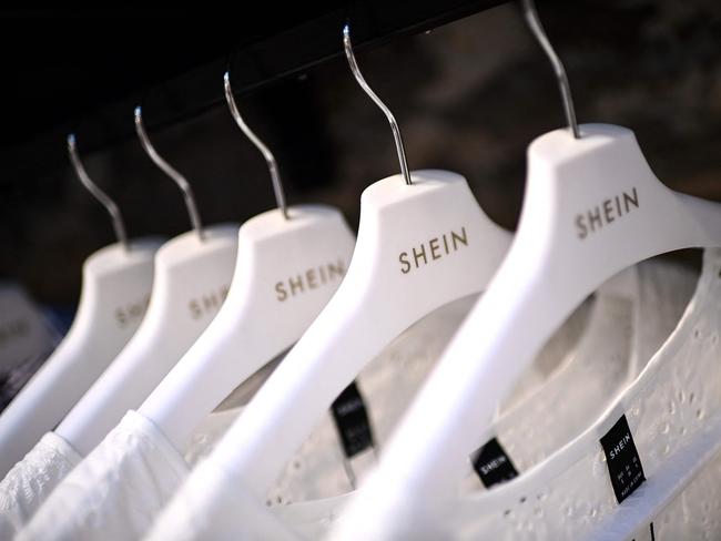 (FILES) Clothes are displayed on hangers at a Chinese fashion brand Shein pop-up store in Paris on May 4, 2023. Shein, the Chinese-founded online fast-fashion giant, could issue plans this week for a stock market listing in London, a source close to the matter told AFP on June 3, 2024. (Photo by Christophe ARCHAMBAULT / AFP)