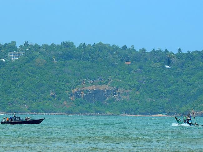 A Sri Lankan navy boat (L) patrols after Sri Lanka transferred 41 would-be asylum seekers whose boat was turned away by Australia at the southern port of Galle on July 7. Picture: Lakruwan Wanniarachchi