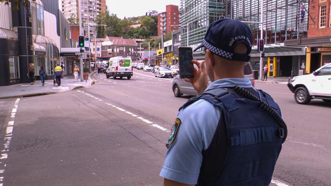 A police officer photographs the intersection on New South Head Rd. Picture: OnScene Bondi