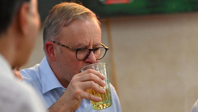 Anthony Albanese drinks at a street vendor's restaurant during an official visit to Vietnam in Hanoi. Picture: Nhac Nguyen