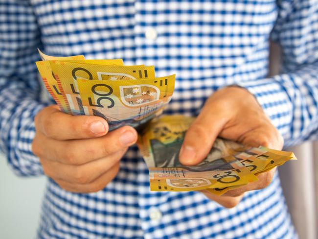Man handling fifty dollar notes finance. Money and bills economy  Picture: istock