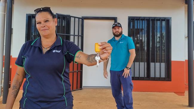 Remote tenancy contract officer Lee Ann Wortley receives the keys to her new home from NT government housing officer Daniel Baker. Picture: Supplied