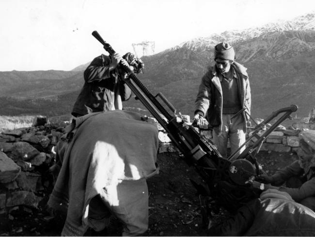 Mujahideen guerrilla fighters look over an anti-aircraft gun in 1988. Picture: London Daily Telegraph.