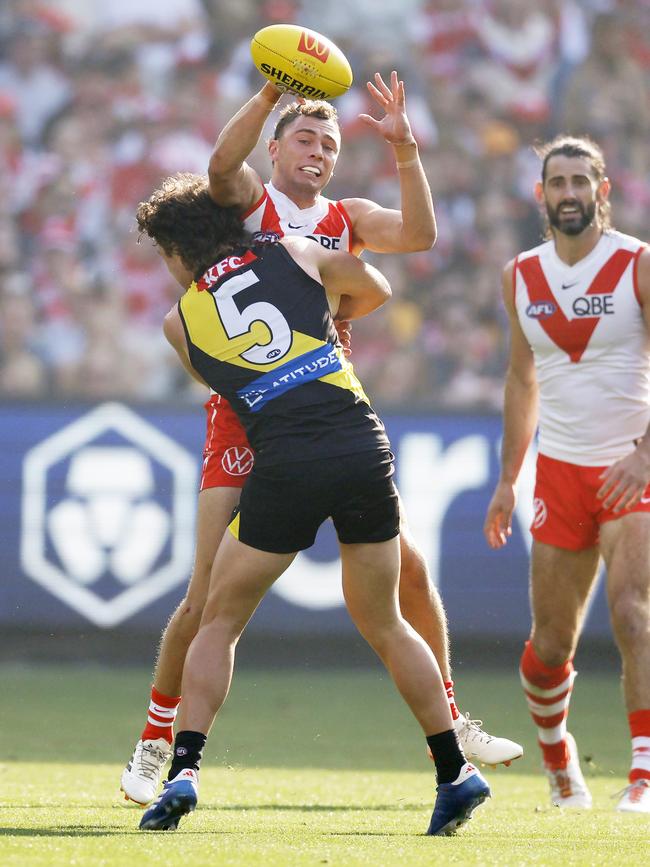 Sydney’s Will Hayward tackled by Richmonds Jack Ross. Picture: Michael Klein