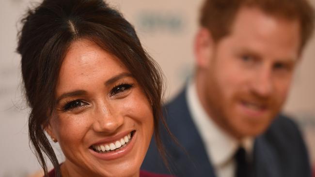 (FILES) In this file photo taken on October 25, 2019 Britain's Prince Harry, Duke of Sussex (R) and Meghan, Duchess of Sussex attend a roundtable discussion on gender equality with The Queen’s Commonwealth Trust (QCT) and One Young World at Windsor Castle in Windsor on October 25, 2019. - Prince Harry and his wife Meghan formally step down as senior members of the British royal family on March 31, 2020, as they start a controversial new life in the United States. (Photo by Jeremy Selwyn / POOL / AFP)