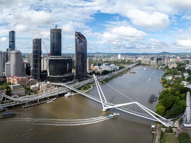 Developing Queensland - Discover the dramatic aerial view of the financial district skyscrapers and Brisbane River in Queensland, Brisbane, Australia, during summer. The stunning skyline and winding river create a picturesque urban landscape perfect for business and leisure.