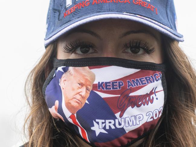 As the US nears election day, a Trump supporter masks up as cases in the US spike. Picture: Getty Images/AFP