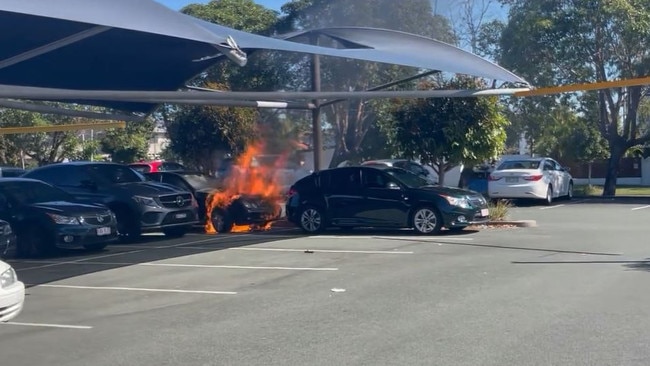 A car has exploded after catching fire in the Runaway Bay Shopping Centre car park. Picture: Calvin Swain