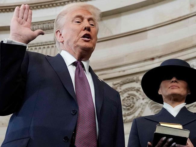 TOPSHOT - Donald Trump is sworn in as the 47th president of the United States by Chief Justice John Roberts as Melania Trump holds the Bible during the 60th Presidential Inauguration in the Rotunda of the U.S. Capitol in Washington, Monday, Jan. 20, 2025. (Photo by Morry Gash / AFP)