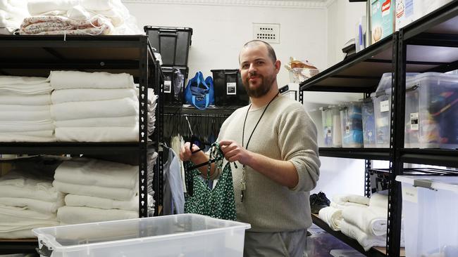 Youth worker Ben Hourn organising essential items the give out at the Blacktown Youth Services Association. Picture: Jonathan Ng