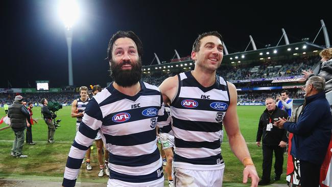 Corey Enright (R) and Jimmy Bartel of the Cats celebrate the win in their milestone games during the round 19 AFL match between the Geelong Cats and the Western Bulldogs in 2016. Picture: Michael Dodge/Getty Images