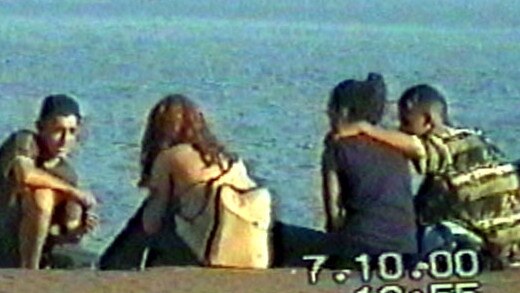 Police surveillance pictures Mohammed Skaf and Tayyab Sheikh with his arm around a young woman at Bondi