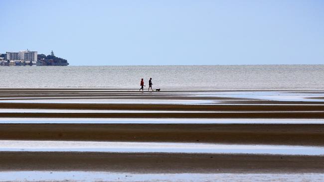 People walking along the Sandgate foreshore, where a 68-year-old woman was punched in the face. Picture: Liam Kidston.