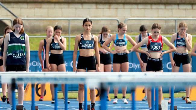 Waiting patiently. (L-R) Famke Cullan of St Paul's Grammar, Jaide Almeida of Newtown High School of The Performing Arts and Sarah-Anne Koot of Cherrybrook Technology High School in the 14 year old hurdles.