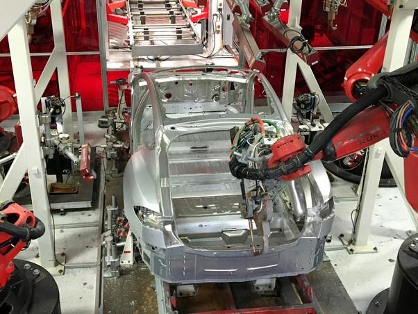 German-made Kuka robots assemble vehicles at the Tesla Motors Inc. factory in Fremont, Calif. PHOTO: JOSEPH WHITE/REUTERS