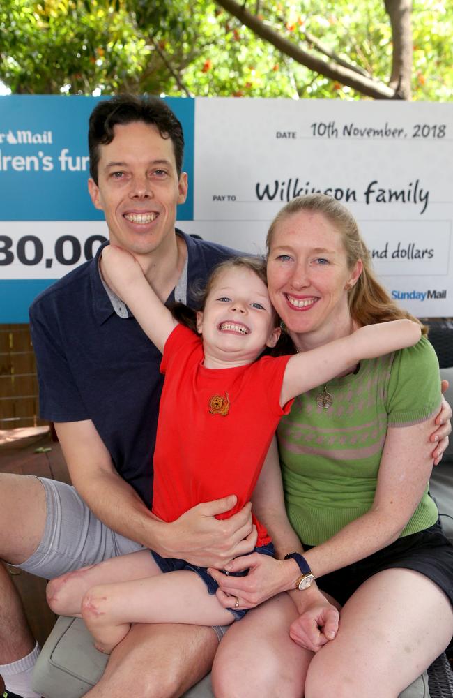 Mia Wilkinson, 5, with dad Peter and mum Amy. Picture: AAP/Steve Pohlner