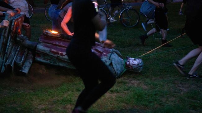 Protesters drag a statue of Christopher Columbus to a nearby pond duringthe height of BLM protests in June. Another statue of Columbus was beheaded in Boston.