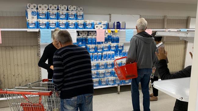 People scramble for toilet paper and other long-life goods at Coles in Sydney’s Chatswood in the midst of coronavirus fuelled fears. Picture: Rohan Kelly