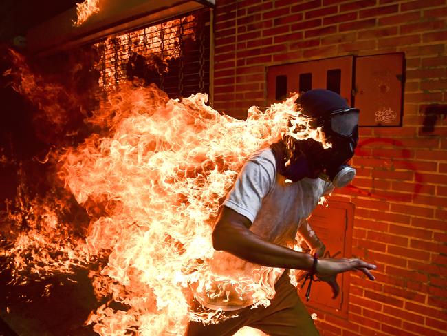 José Víctor Salazar Balza (28) catches fire amid violent clashes with riot police during a protest against President Nicolas Maduro, in Caracas, Venezuela. Picture: Ronaldo Schemidt/AFP/World Press Photo