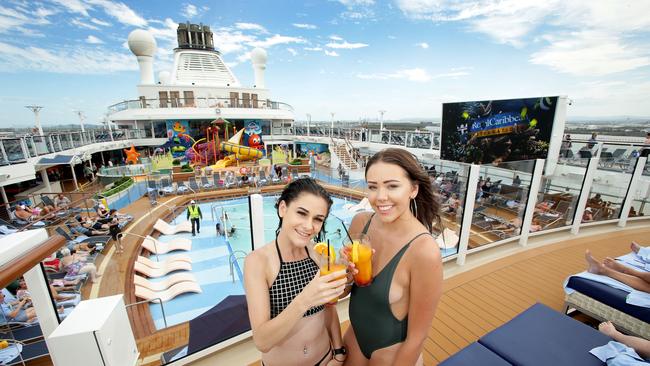 Michaela Field and Maddi Coulduck, both of Sydney, enjoy a cocktail on-board Ovation of the Seas while docked in Brisbane. Picture: Mark Calleja