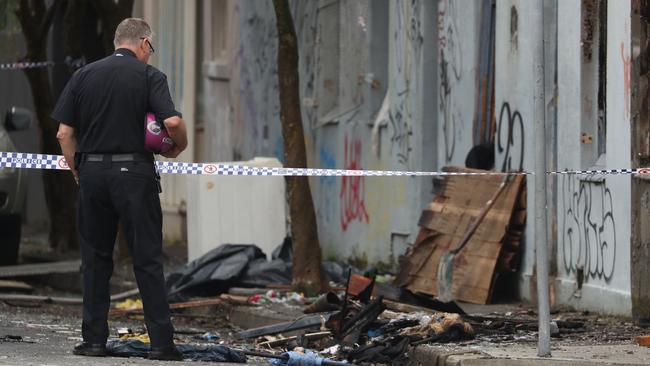 A chaplain surveys the destruction at Vajda House, Newtown, after the deadly fire. Picture: John Grainger