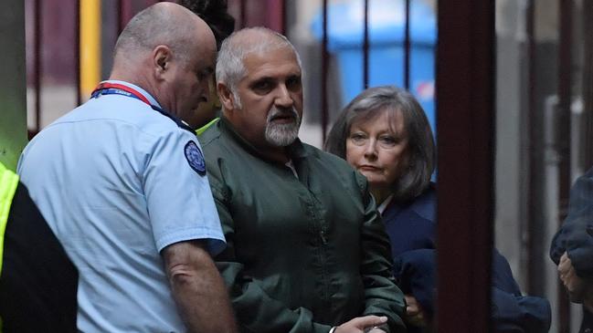 Paulino (centre) arrives at court in 2017. AAP Image/Tracey Nearmy