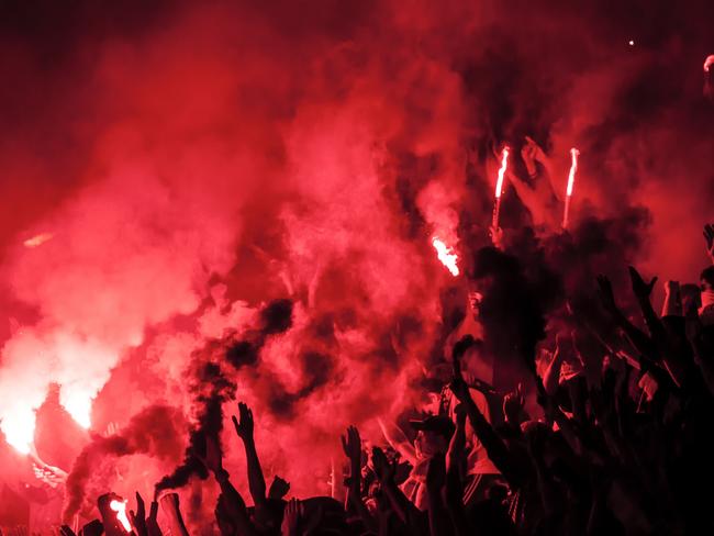 Football fans lit up the lights, flares and smoke bombs. Protest concept.Football fans lit up the lights, flares and smoke bombs. Istock