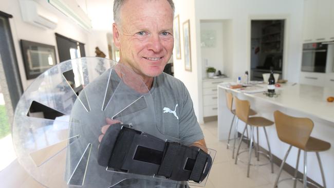 Pictured at his Clear Island Waters home Bruce Oxenford with his arm shield. Picture: Mike Batterham