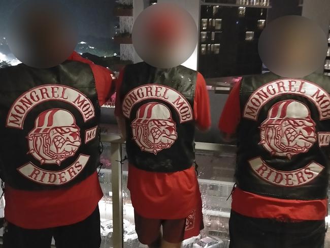 A trio of men believed to be affiliated with the North Queensland chapter flaunting their Mongrel Mob colours.