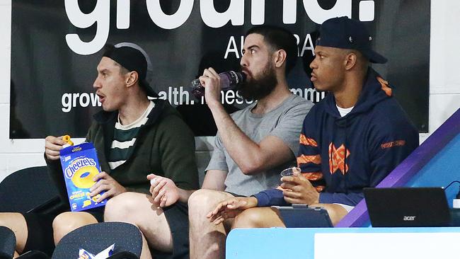 Cairns Taipans players Jarrod Kenny, Jordan Ngatai and Scott Machado watch the NBL1 North match between the Cairns Dolphins and the Townsville Flames at Cairns Basketball Stadium during the NBL off-season. Picture: Brendan Radke