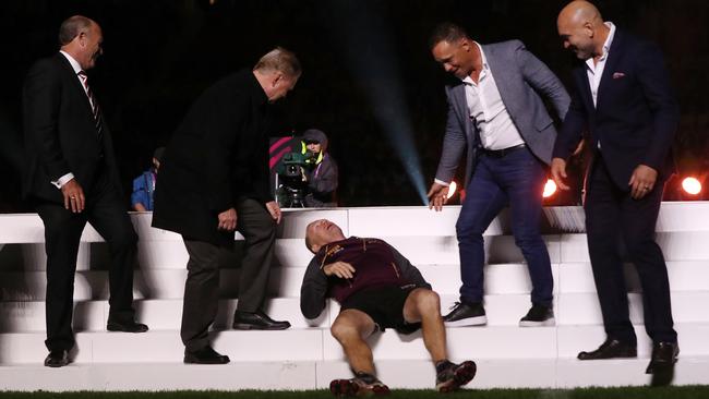 Trevor Gillmeister falls off the stage after a group of former skippers are presented to the crowd. Picture: Peter Wallis