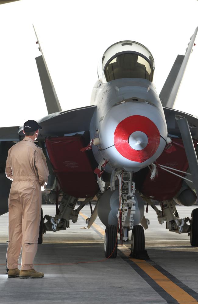 Close up ... RAAF Group Captain Robb with one of the F/A18F jets in the Middle East. Picture: Gary Ramage